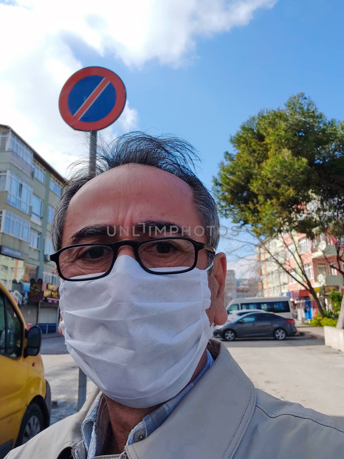 Portrait of man with surgical mask on face against SARS-CoV-2