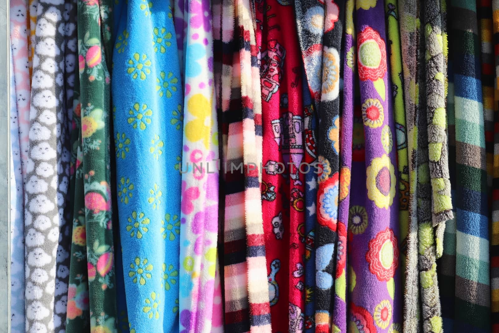 Detailed close up view on samples of cloth and fabrics in different colors found at a fabrics market.