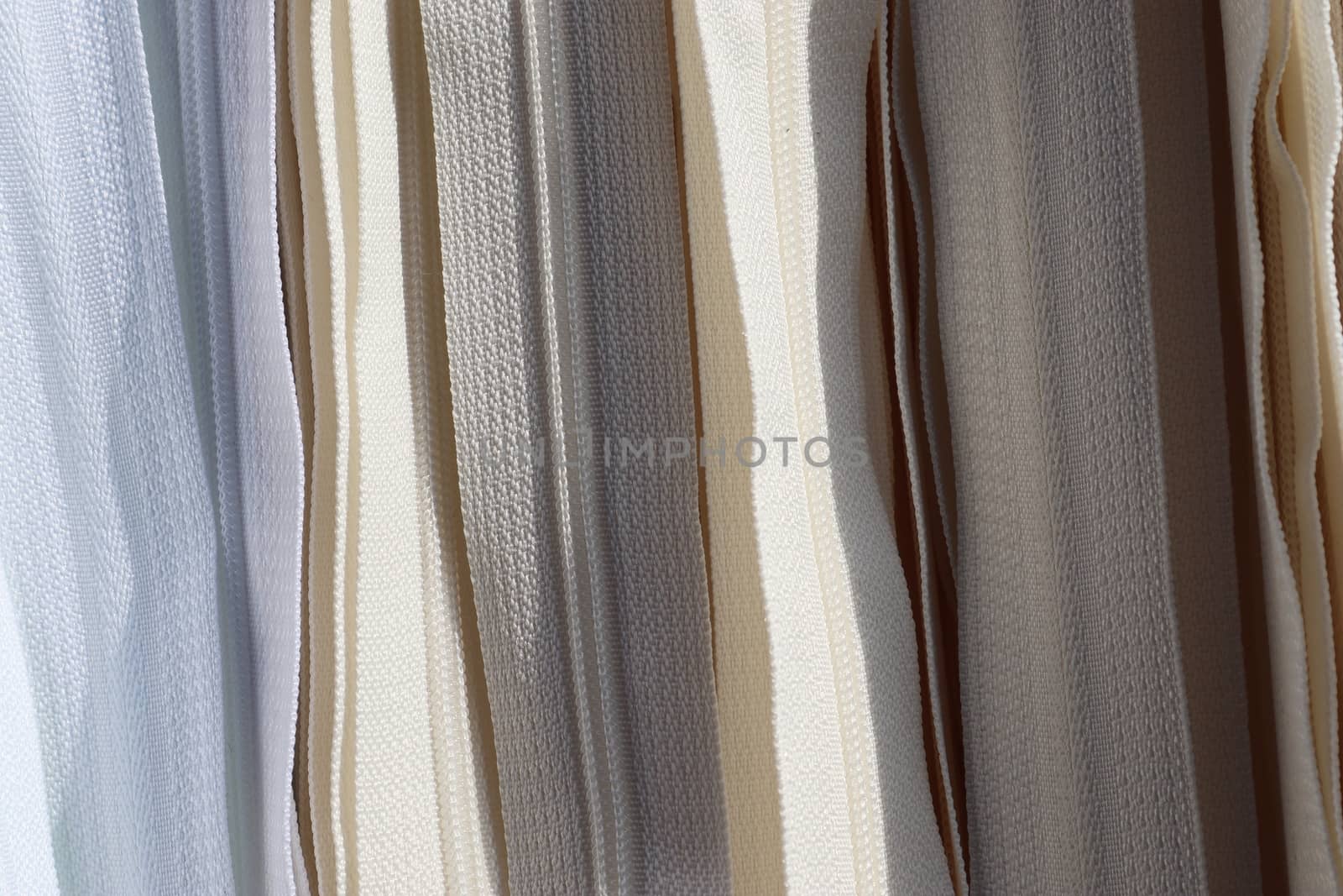 Detailed close up view on samples of cloth and fabrics in different colors found at a fabrics market.