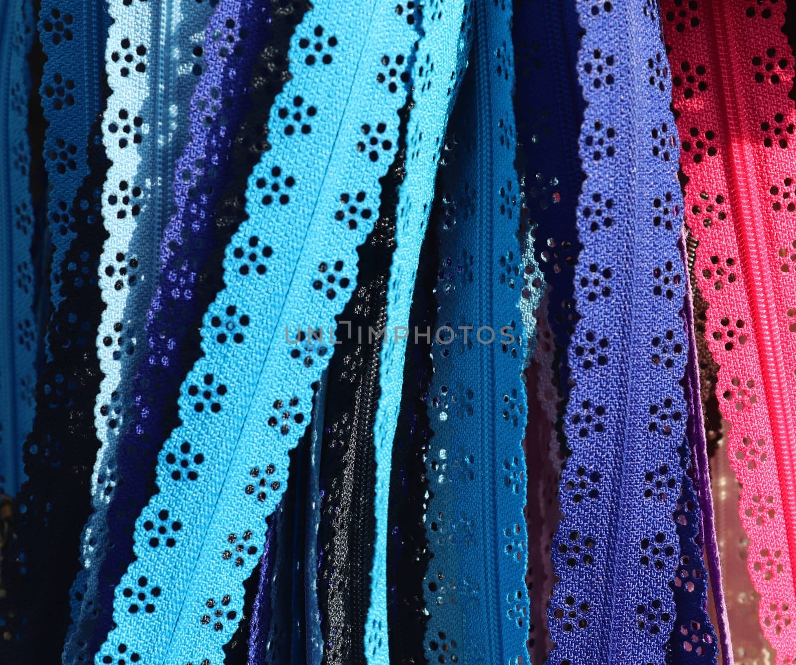 Detailed close up view on samples of cloth and fabrics in different colors found at a fabrics market.