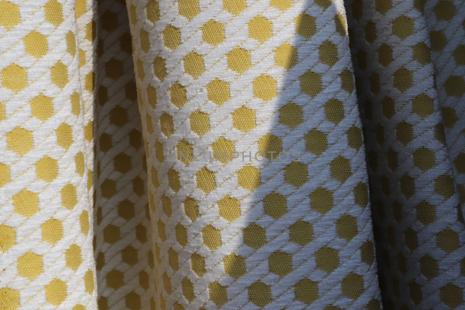 Detailed close up view on samples of cloth and fabrics in different colors found at a fabrics market.