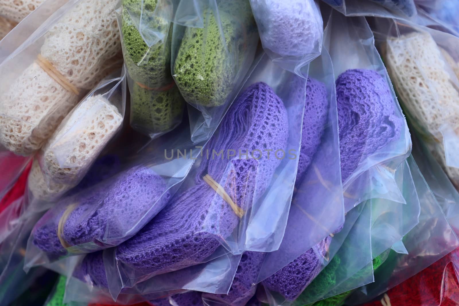 Detailed close up view on samples of cloth and fabrics in different colors found at a fabrics market.