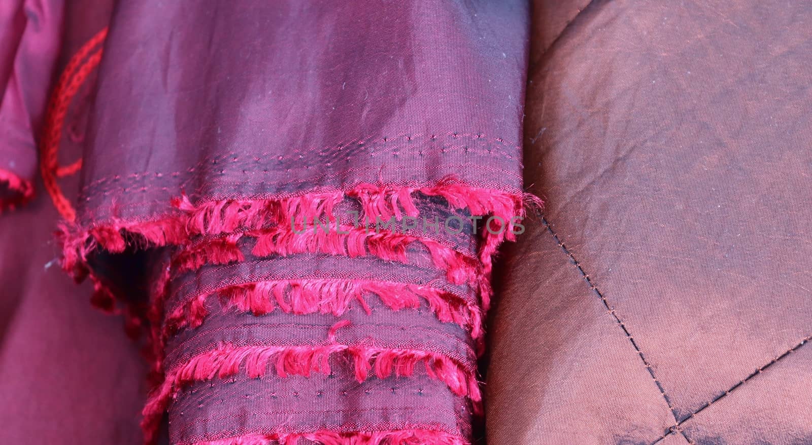 Detailed close up view on samples of cloth and fabrics in different colors found at a fabrics market.