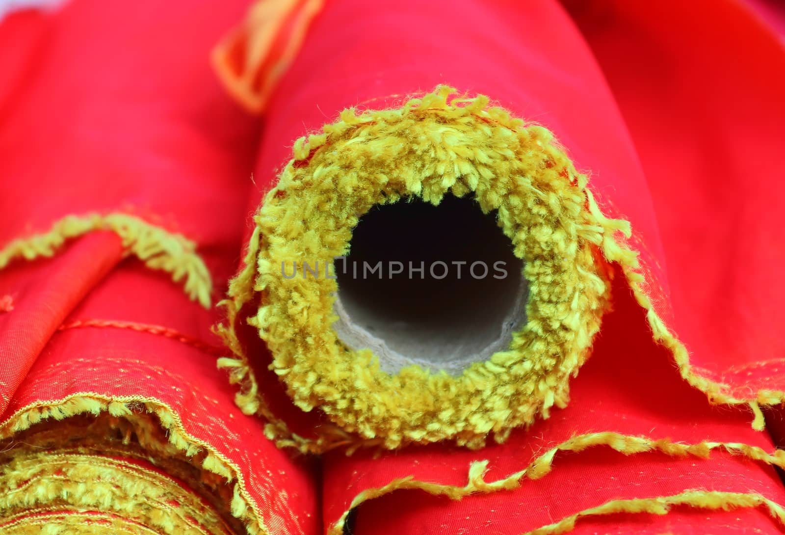 Detailed close up view on samples of cloth and fabrics in different colors found at a fabrics market.