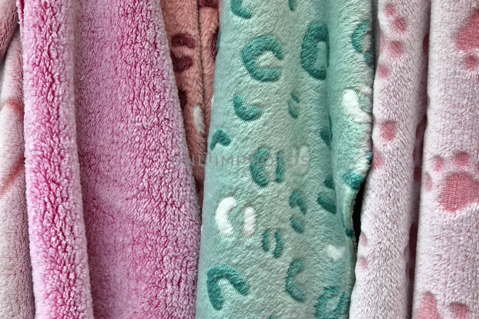 Detailed close up view on samples of cloth and fabrics in different colors found at a fabrics market.