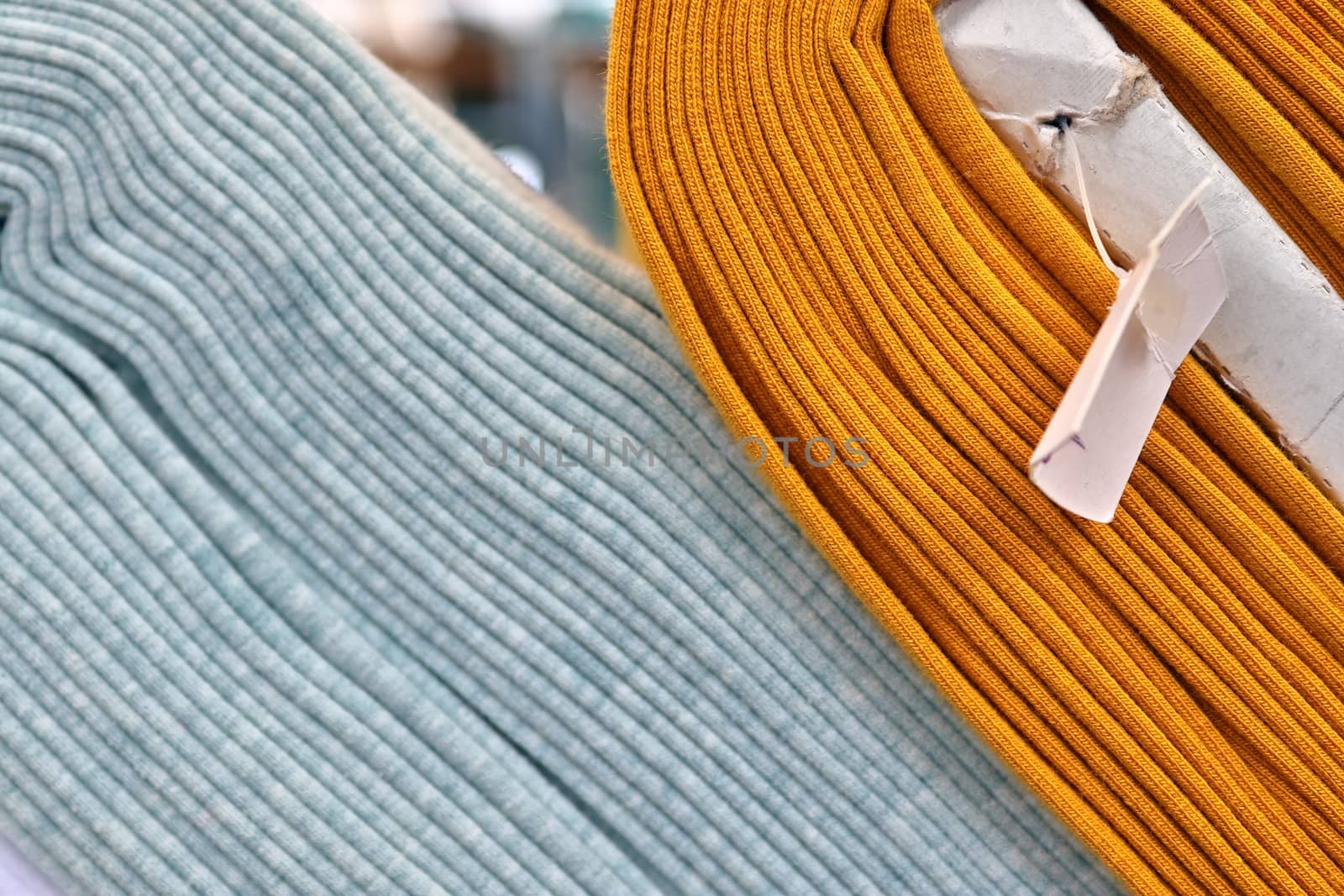 Detailed close up view on samples of cloth and fabrics in different colors found at a fabrics market.