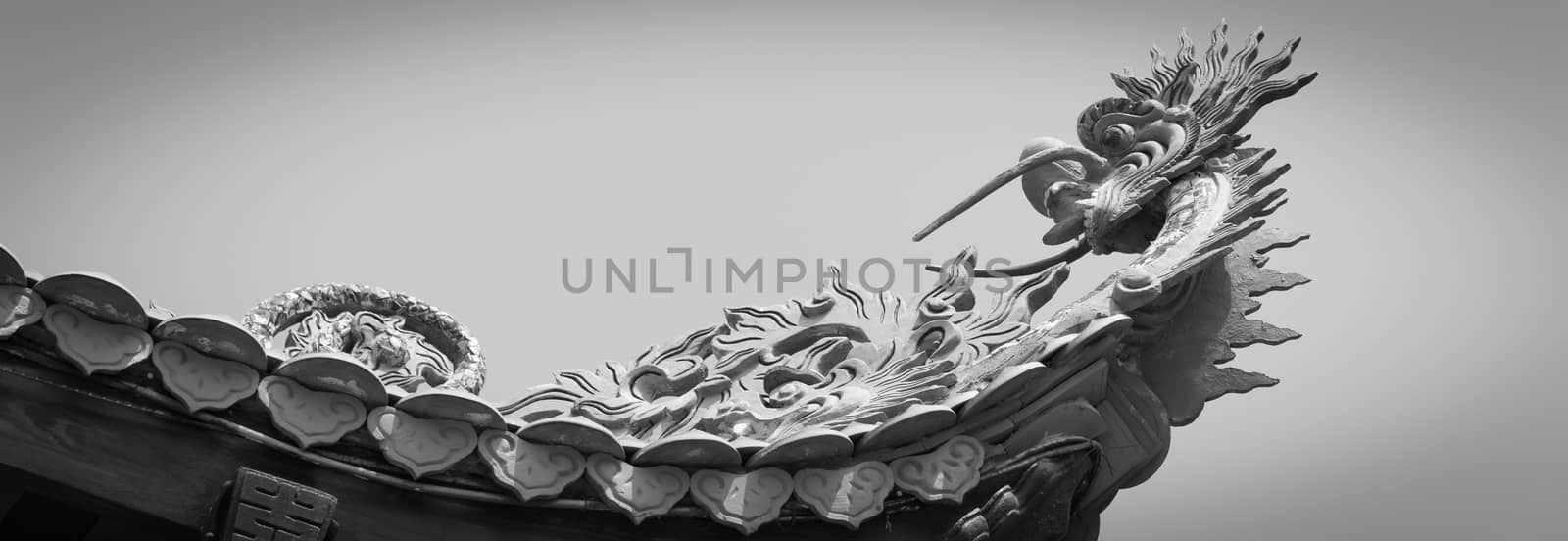 Panoramic upward view typical cornice roof with dragon head sculpture and red tile roof in Vietnam by trongnguyen