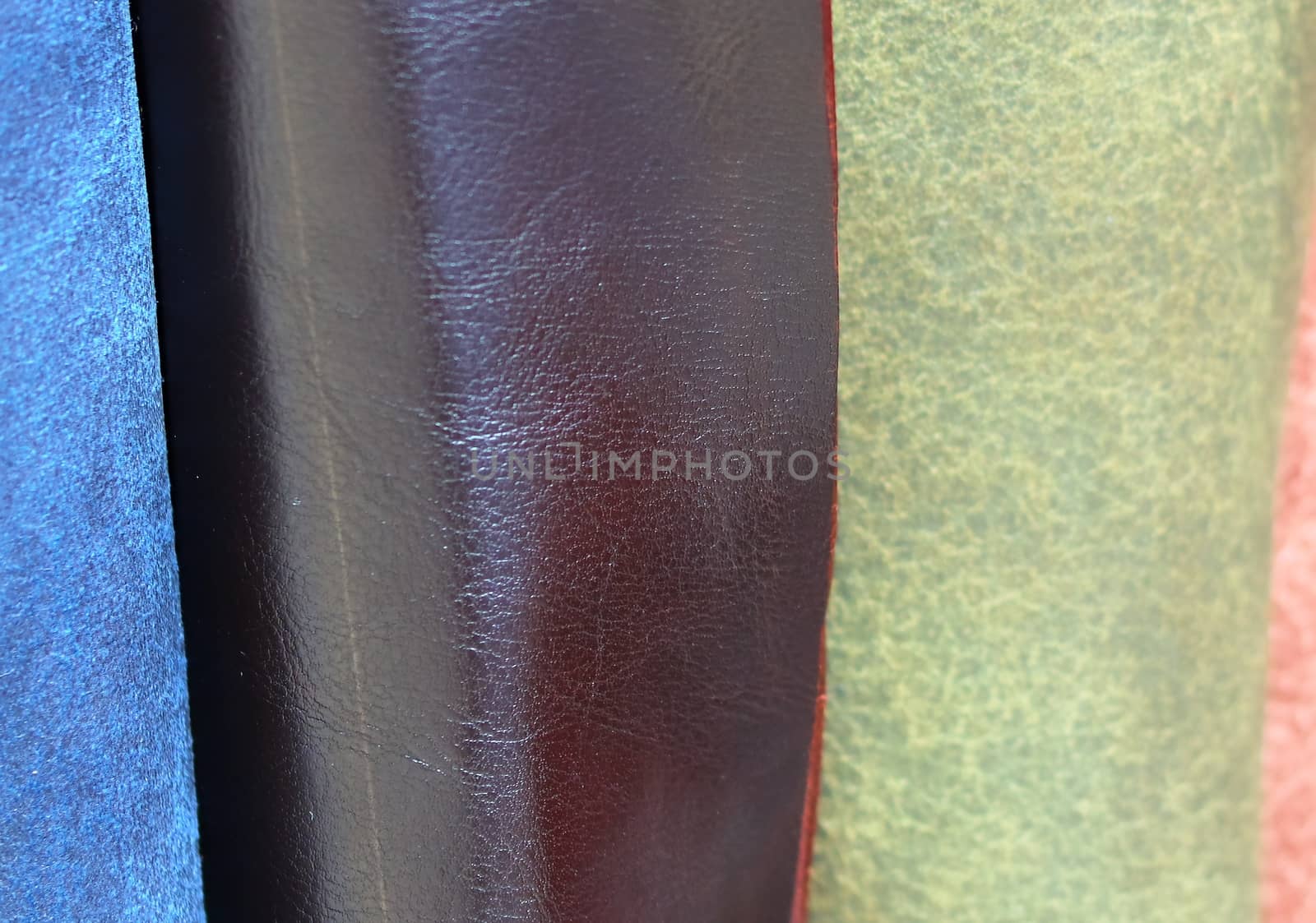 Detailed close up view on samples of cloth and fabrics in different colors found at a fabrics market.