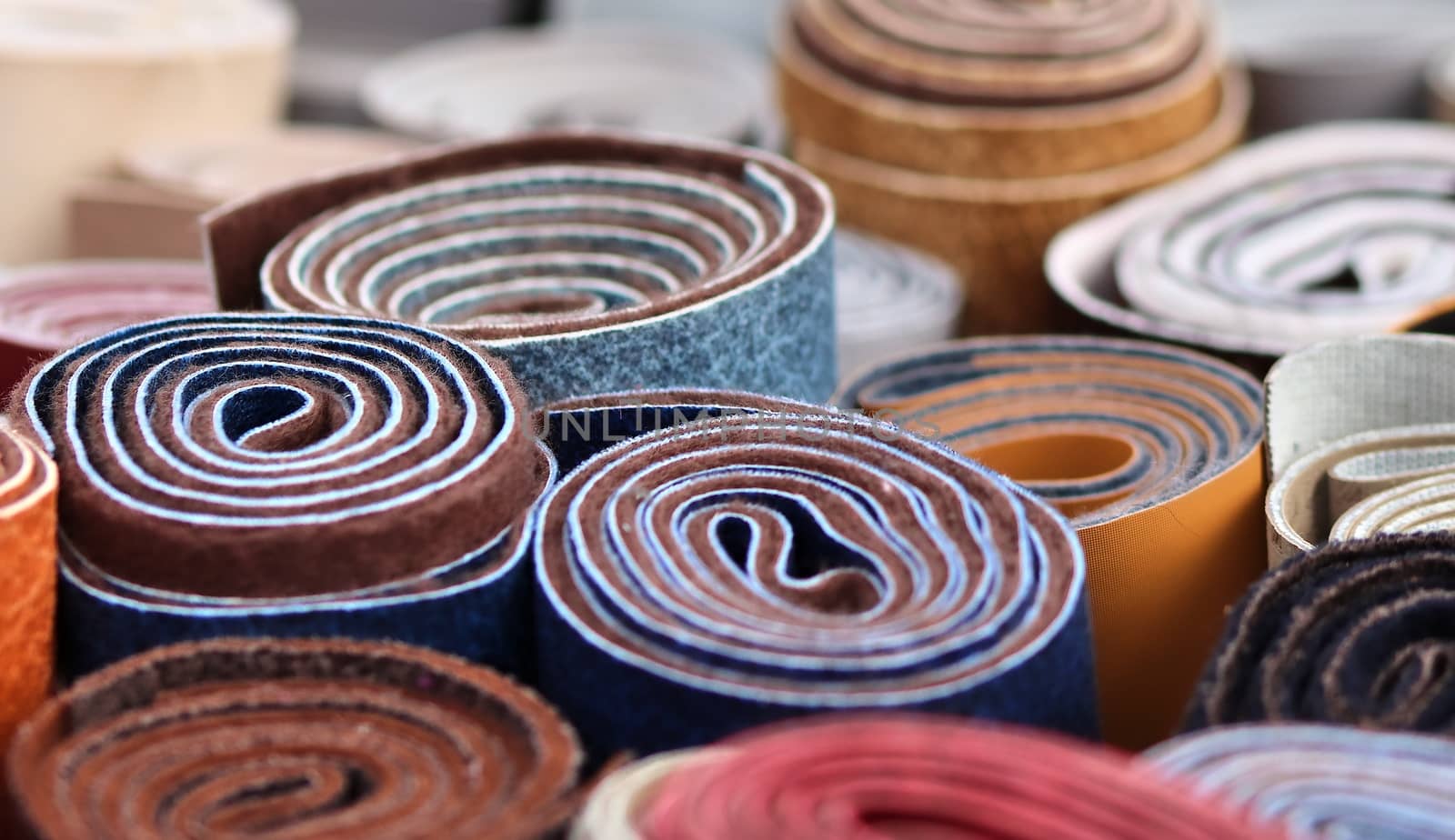 Detailed close up view on samples of cloth and fabrics in different colors found at a fabrics market.