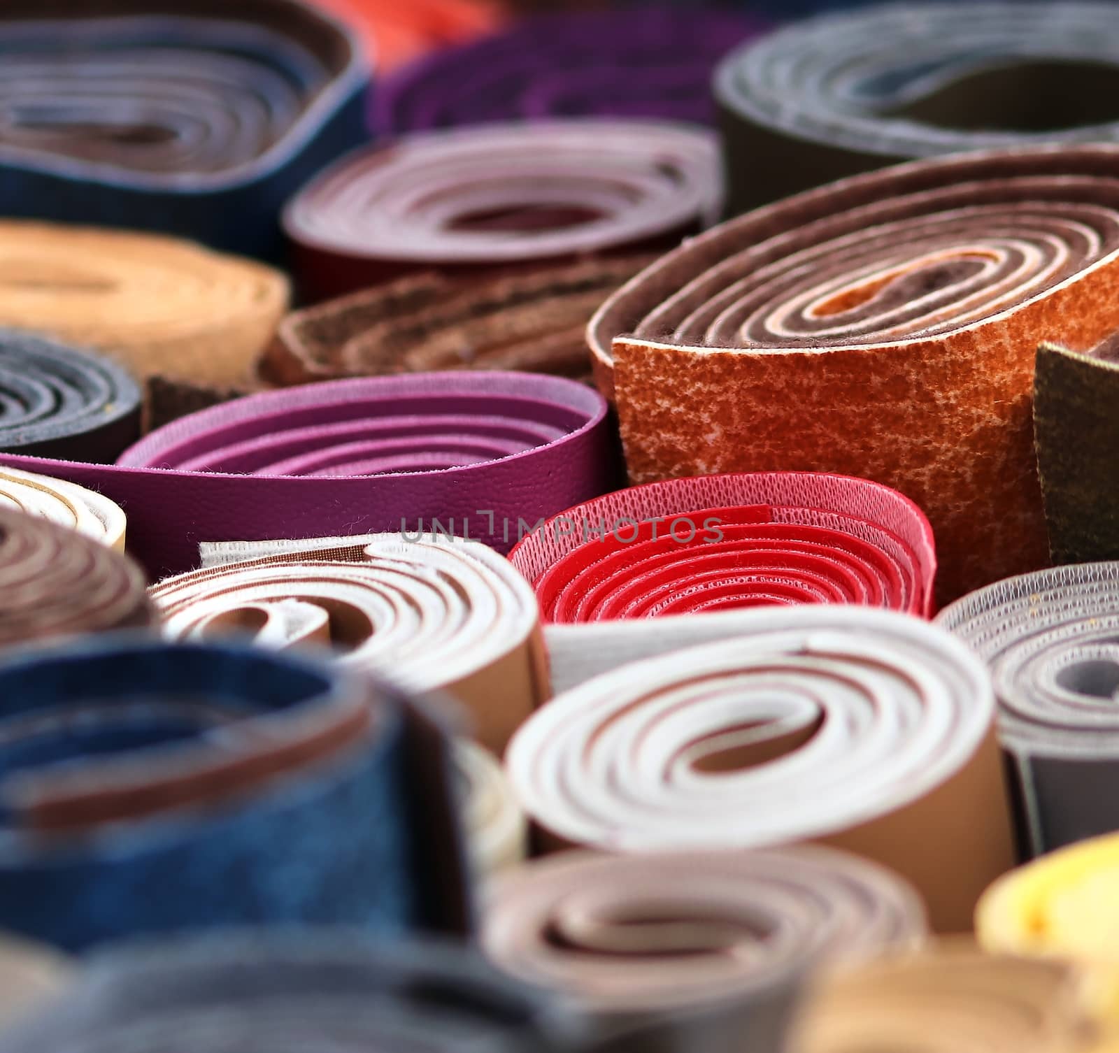 Detailed close up view on samples of cloth and fabrics in different colors found at a fabrics market.