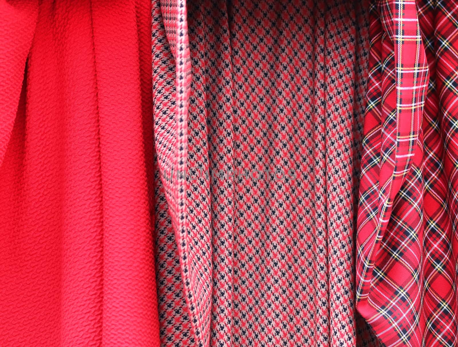 Detailed close up view on samples of cloth and fabrics in different colors found at a fabrics market.