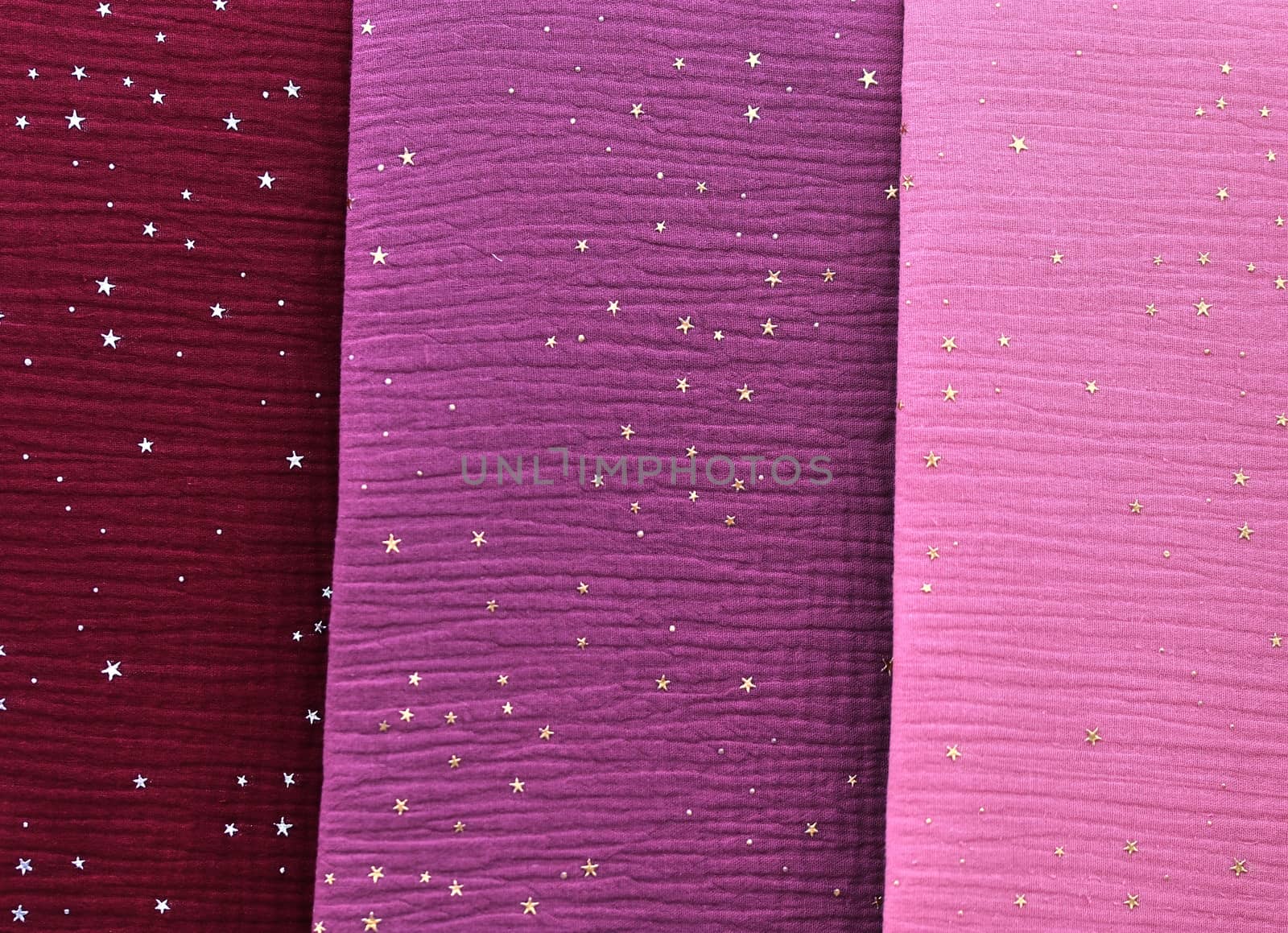 Detailed close up view on samples of cloth and fabrics in different colors found at a fabrics market.