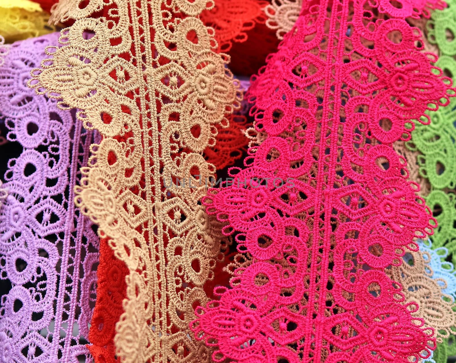 Detailed close up view on samples of cloth and fabrics in different colors found at a fabrics market.