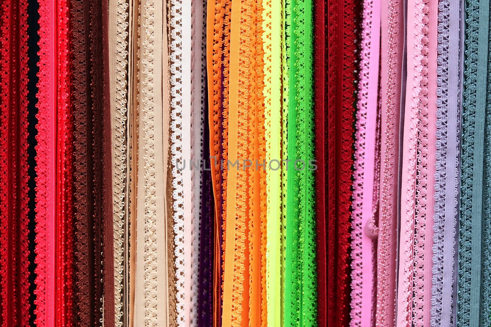 Detailed close up view on samples of cloth and fabrics in different colors found at a fabrics market.