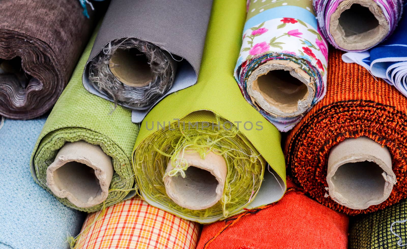 Detailed close up view on samples of cloth and fabrics in different colors found at a fabrics market.