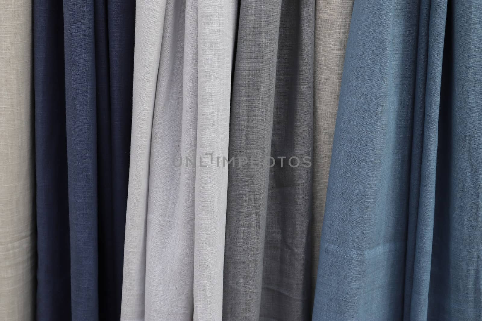 Detailed close up view on samples of cloth and fabrics in different colors found at a fabrics market.