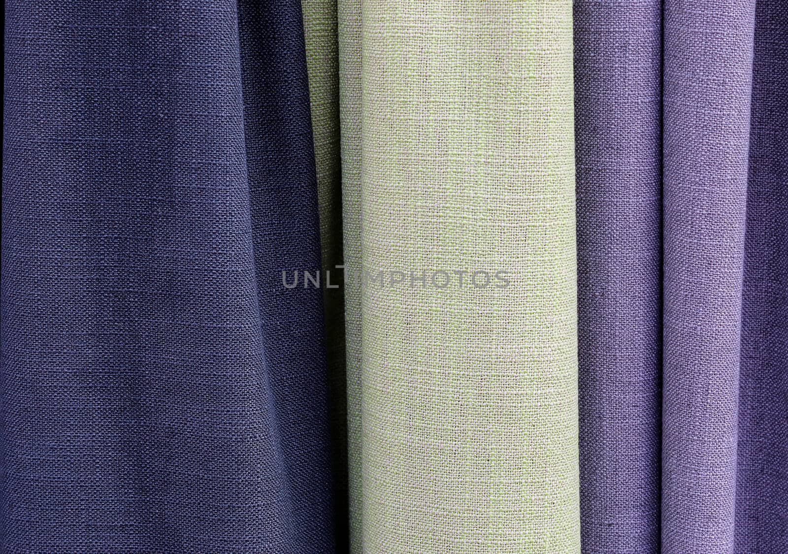 Detailed close up view on samples of cloth and fabrics in different colors found at a fabrics market.