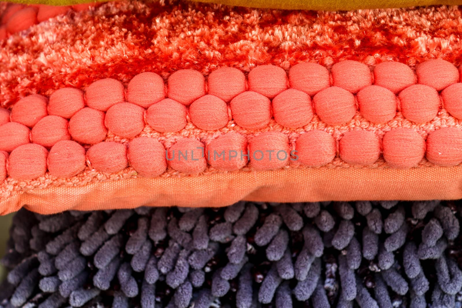 Detailed close up view on samples of cloth and fabrics in different colors found at a fabrics market.