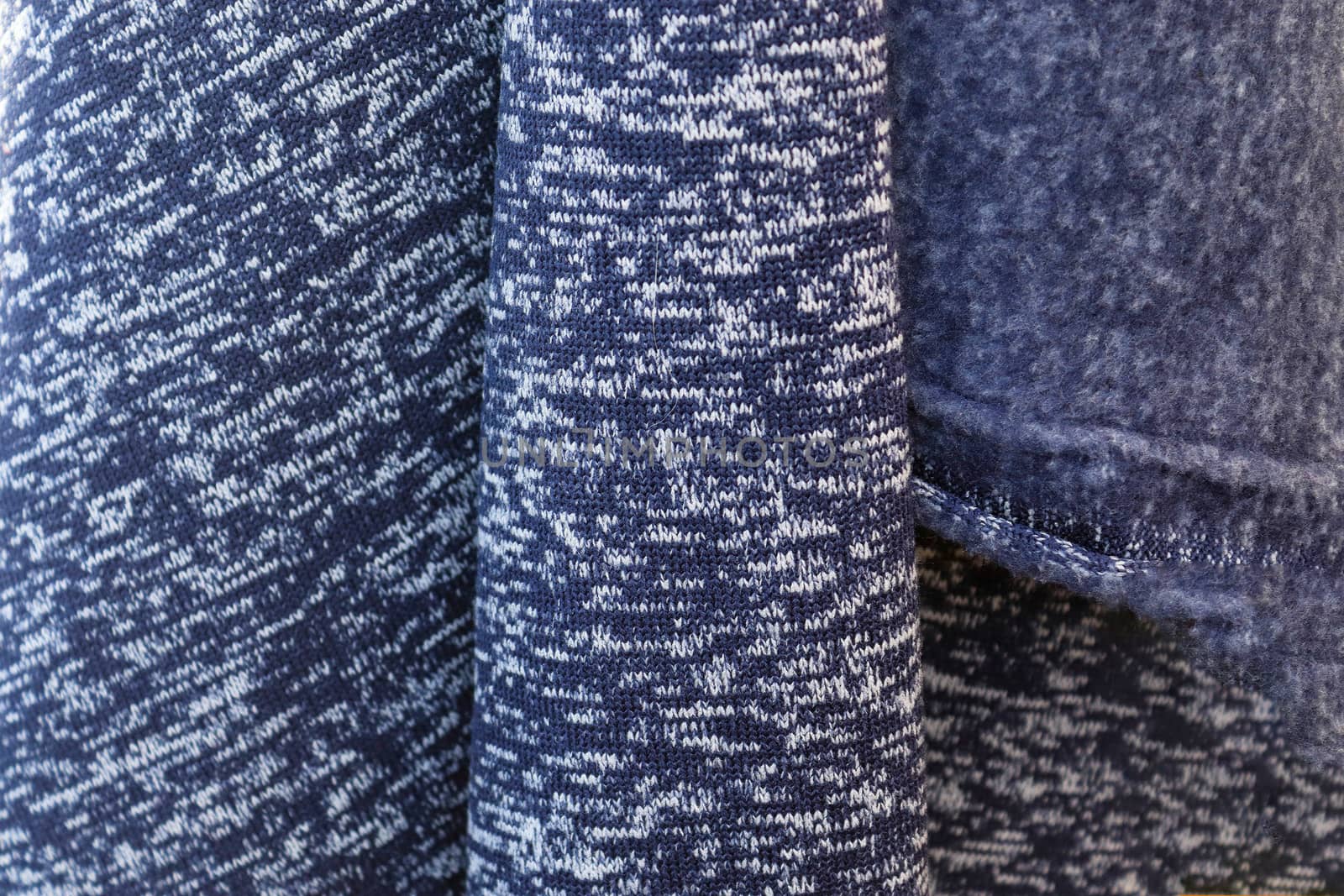 Detailed close up view on samples of cloth and fabrics in different colors found at a fabrics market.