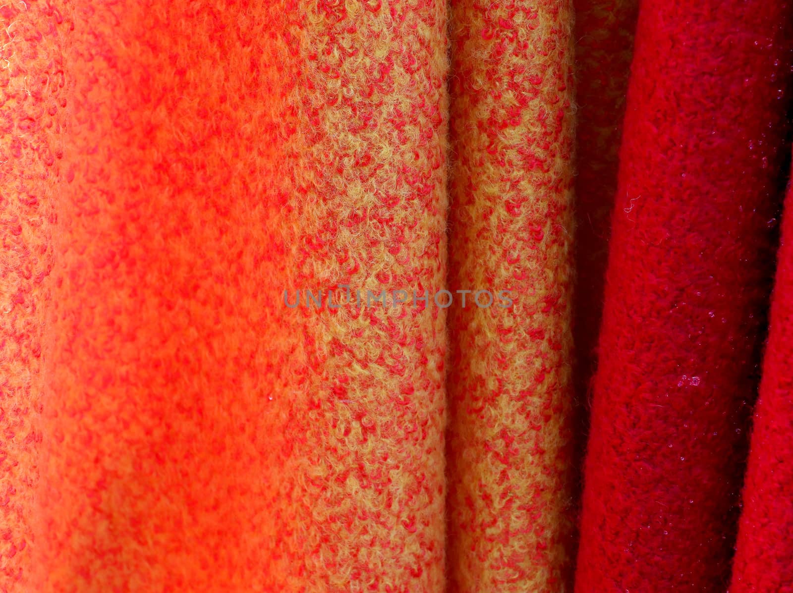 Detailed close up view on samples of cloth and fabrics in different colors found at a fabrics market.