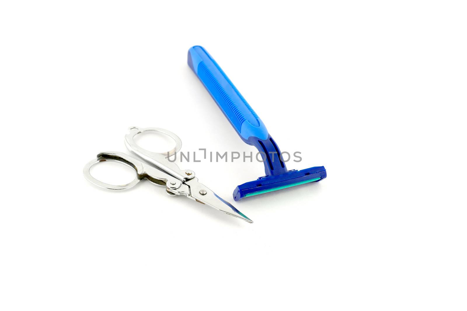 Shaving-set and nail scissors over white by sergpet