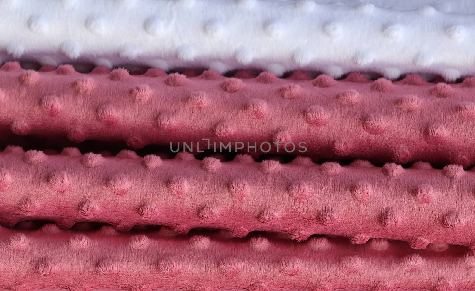 Detailed close up view on samples of cloth and fabrics in different colors found at a fabrics market.