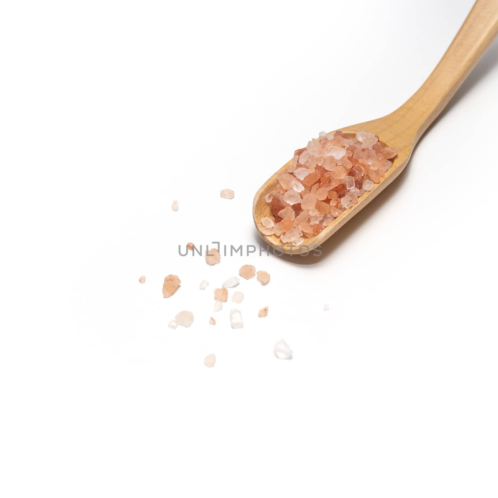 Himalayan pink salt with wooden spoon on table