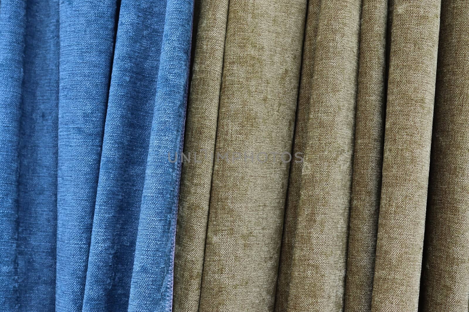 Detailed close up view on samples of cloth and fabrics in different colors found at a fabrics market.