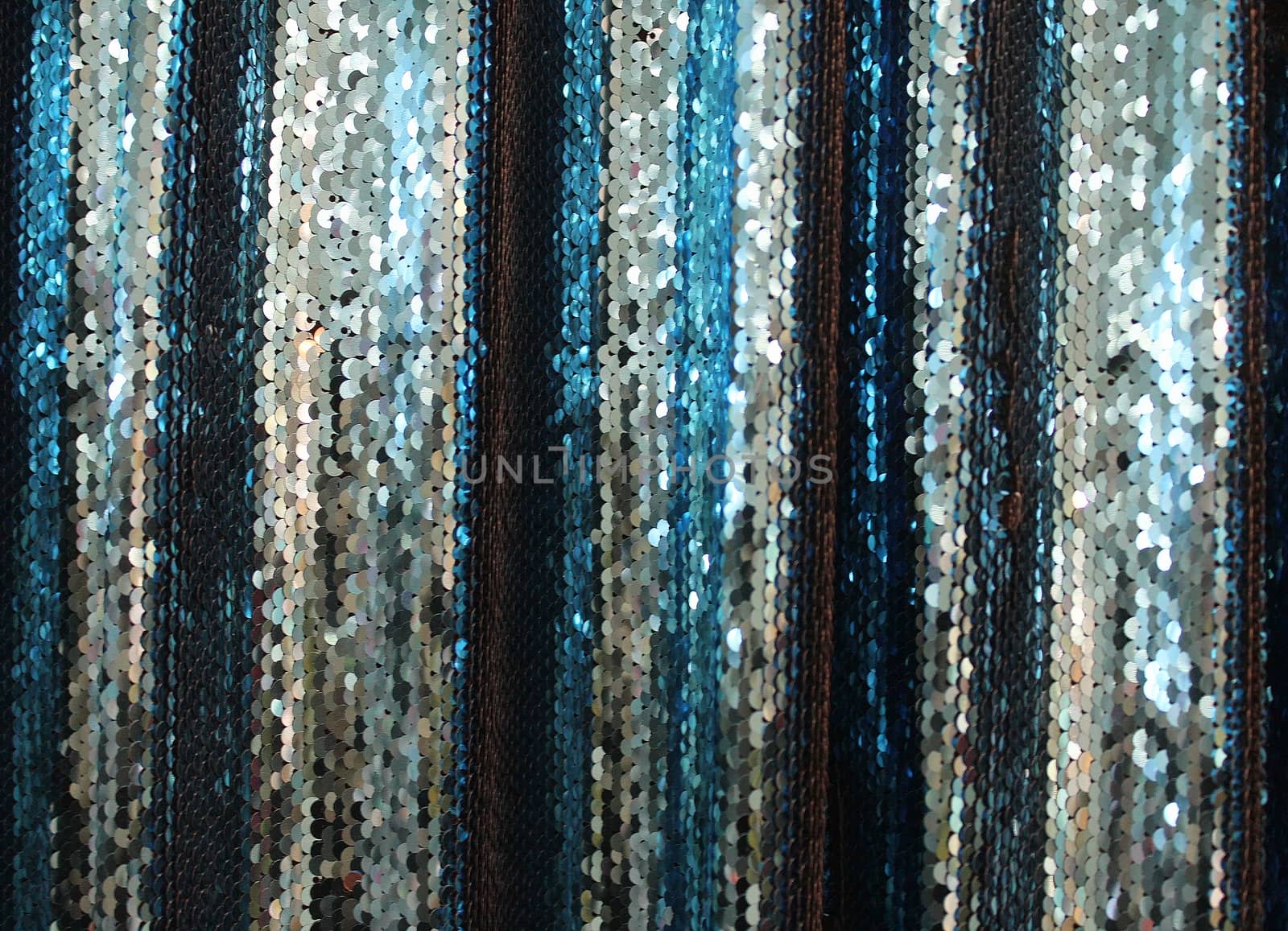 Detailed close up view on samples of cloth and fabrics in different colors found at a fabrics market.