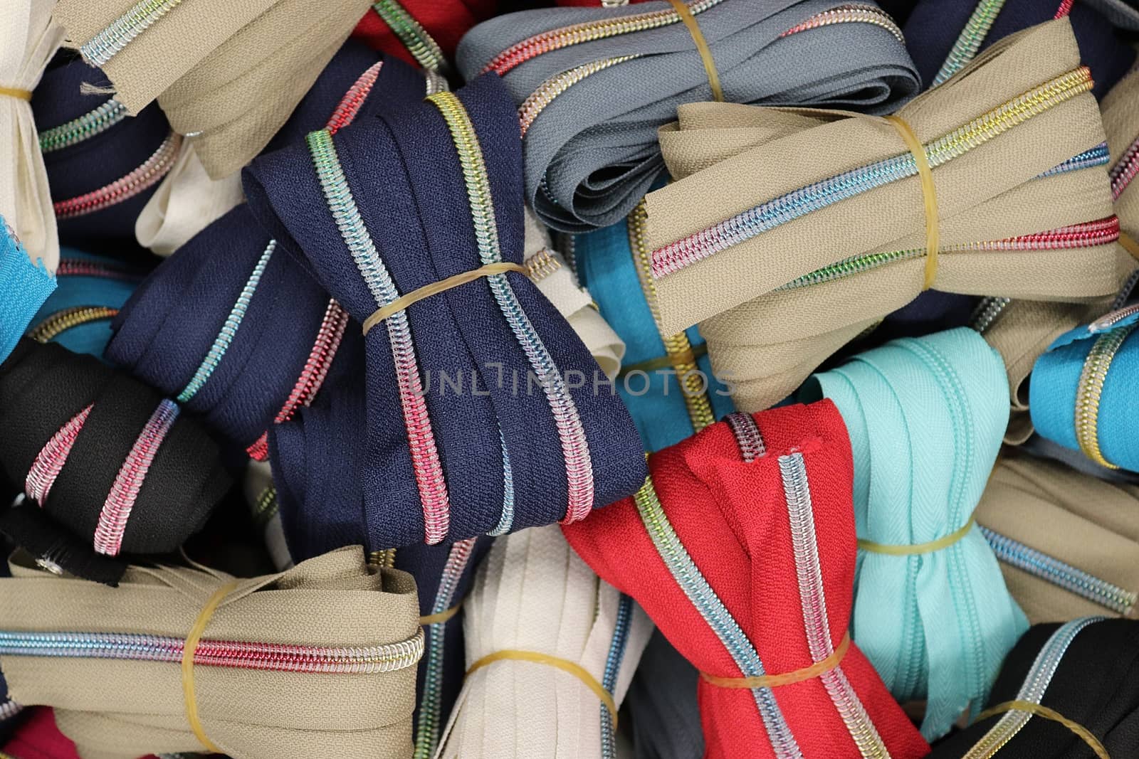 Detailed close up view on samples of cloth and fabrics in different colors found at a fabrics market.