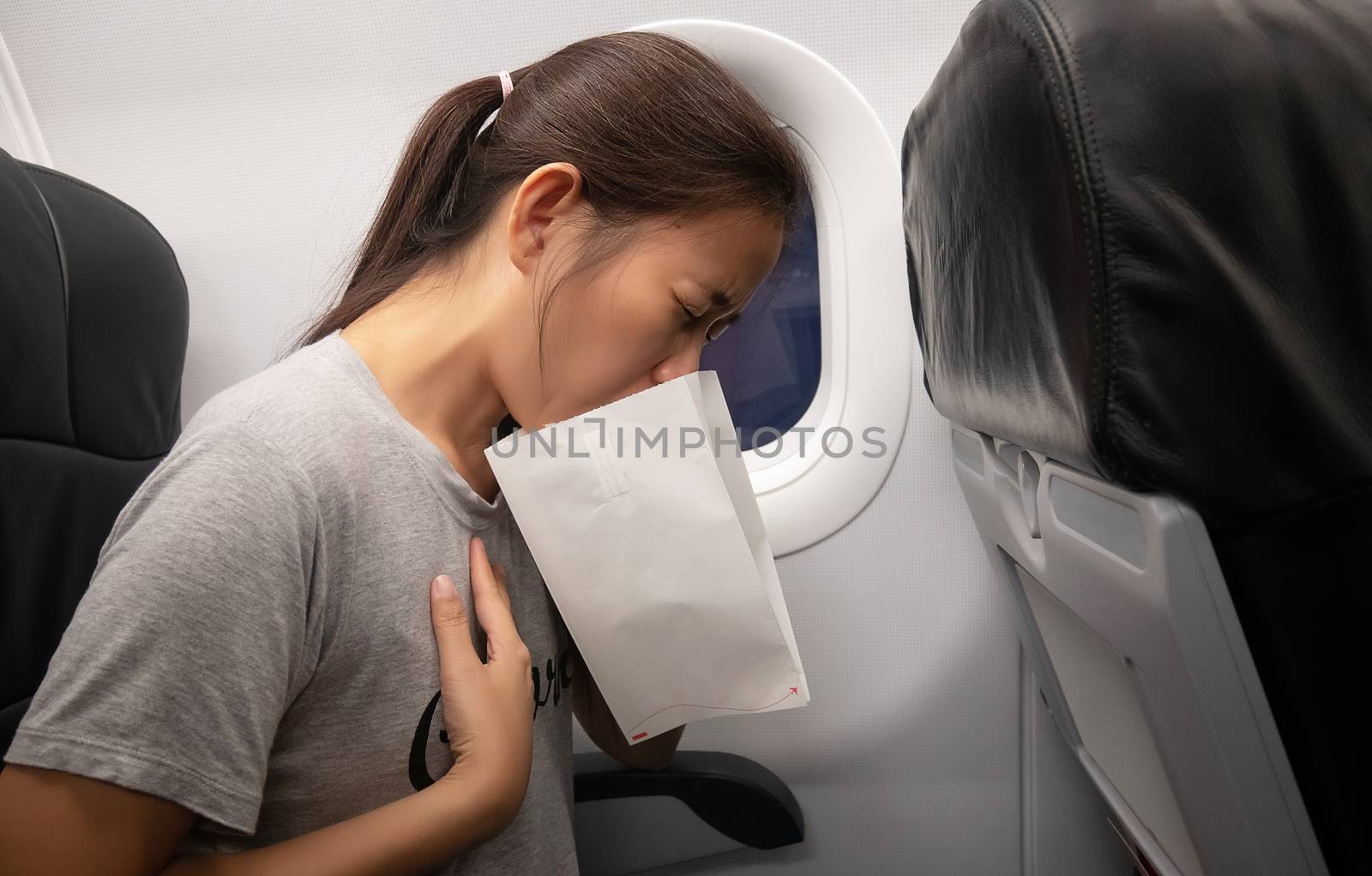 female passenger on the plane felt airsick, affected with nausea by asiandelight