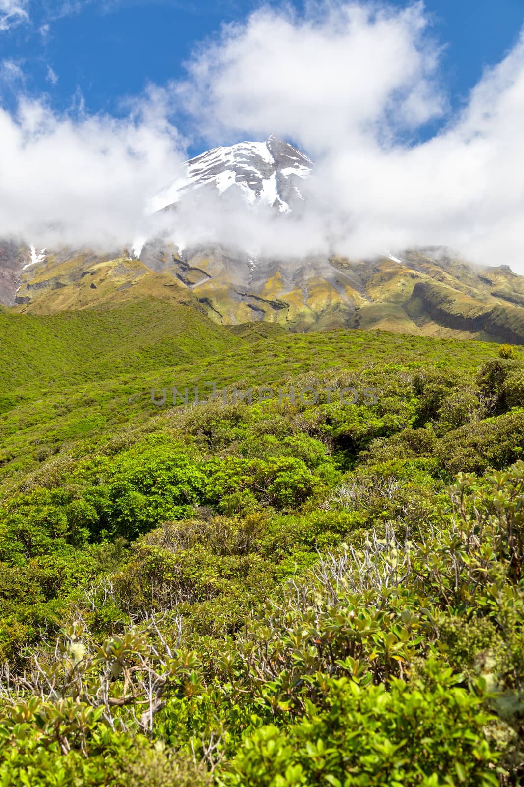 An image of the volcano Taranaki covered in clouds, New Zealand