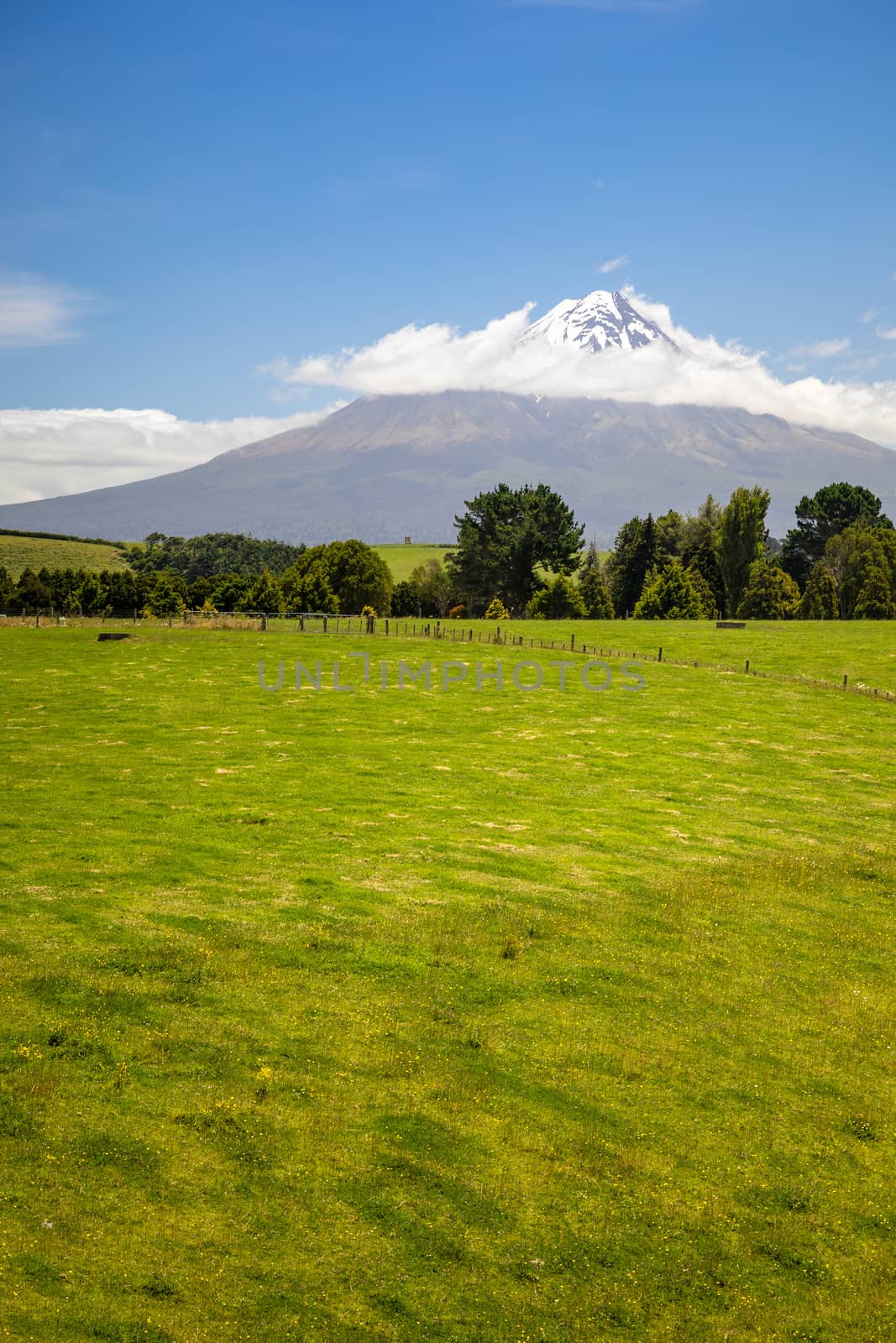 An image of the volcano Taranaki covered in clouds, New Zealand