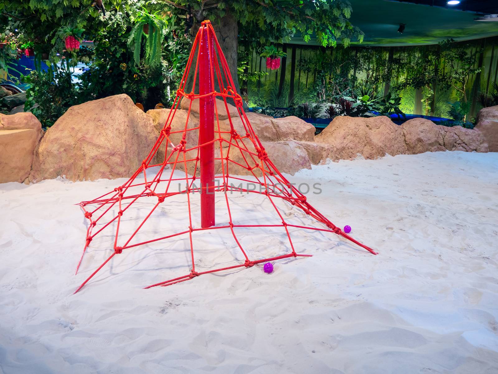 The Children's playground, a place to climb the net. white sand in modern building