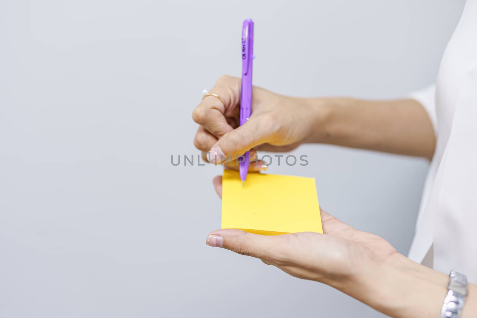 Post-it note with hand on white background