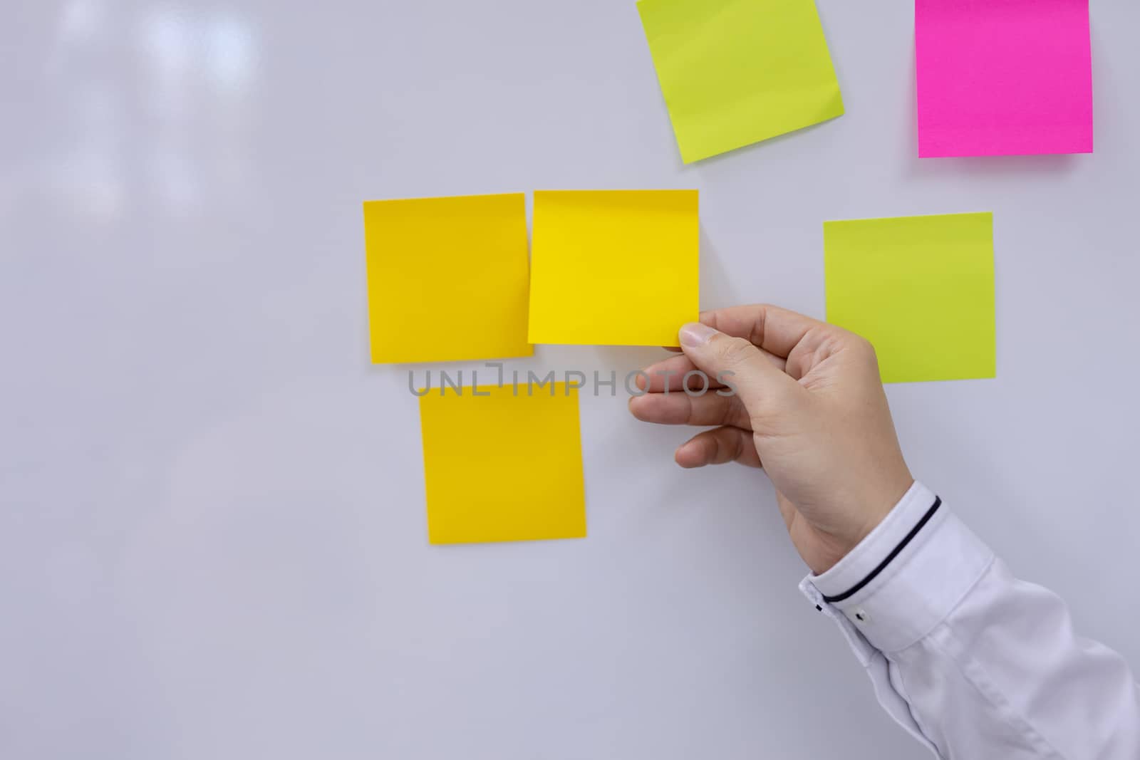 Post-it note with hand on white background