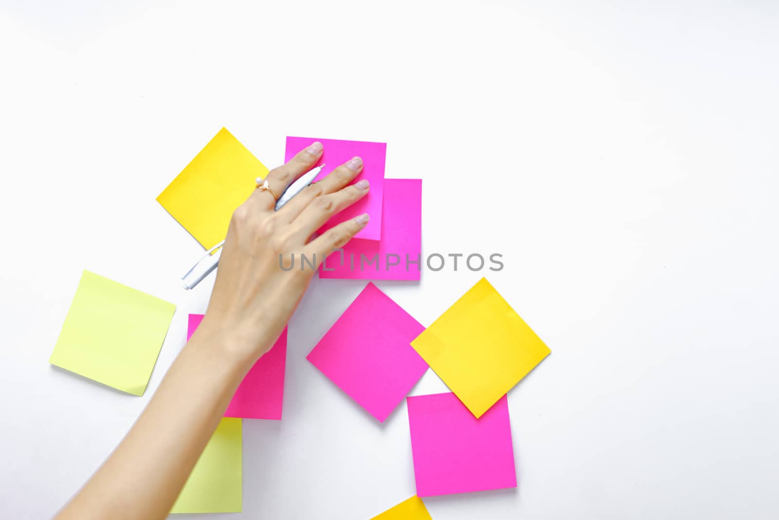 Post-it note with hand on white background