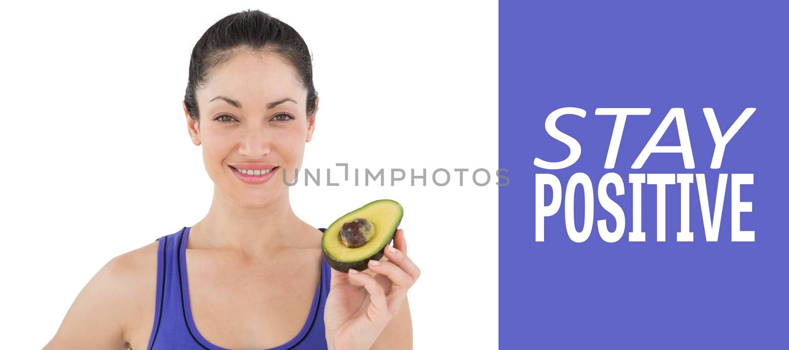 Pretty woman showing half of an avocado  against purple vignette
