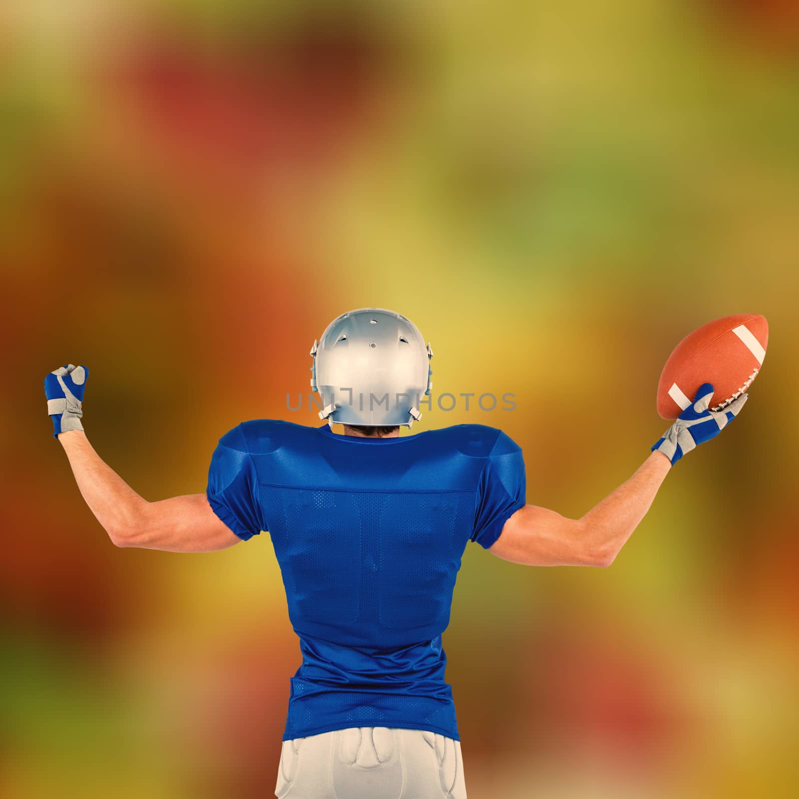 Composite image of rear view of american football player holding ball by Wavebreakmedia
