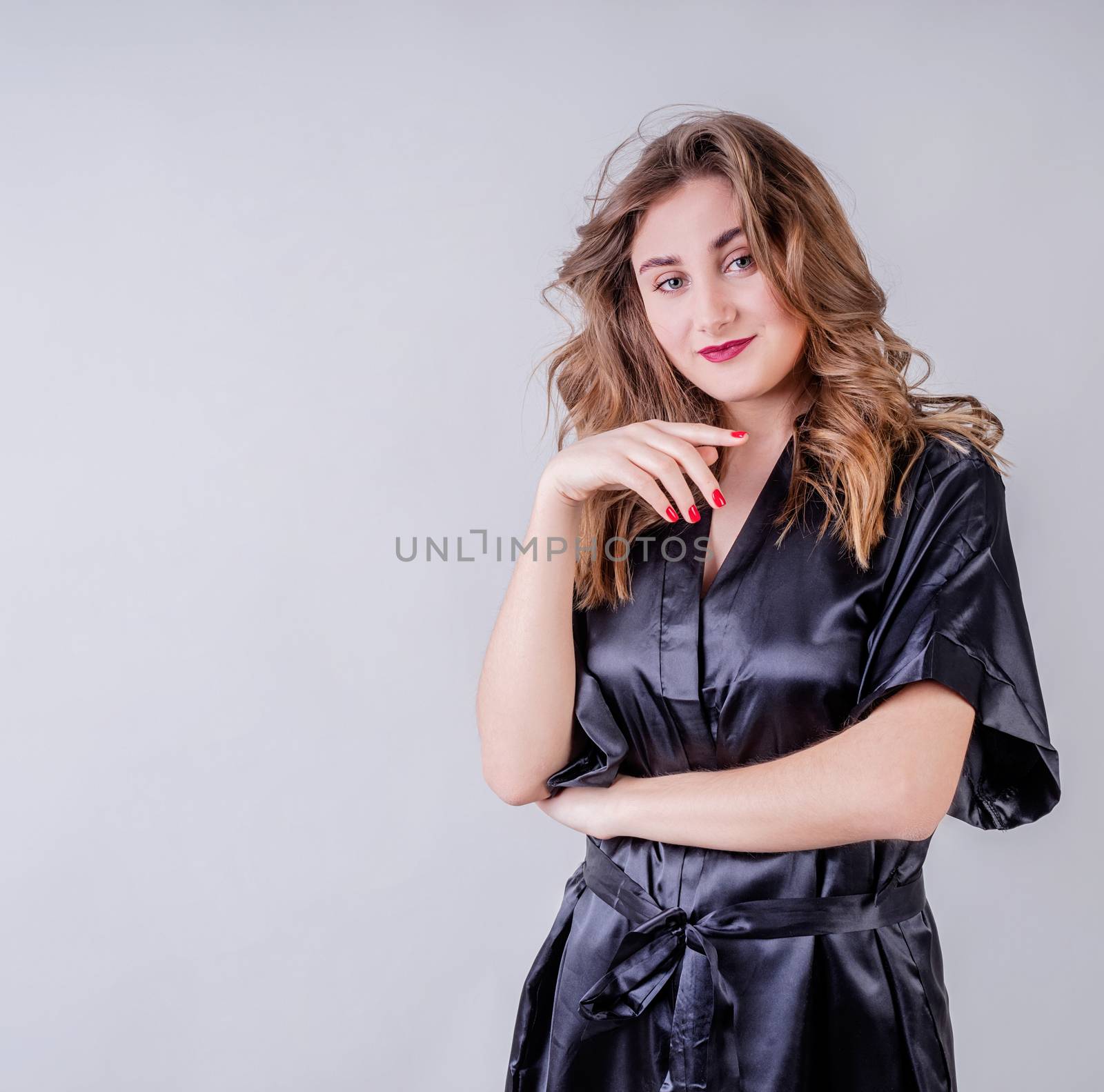 Laundry concept. Sexy housewife in black pajamas isolated on gray background