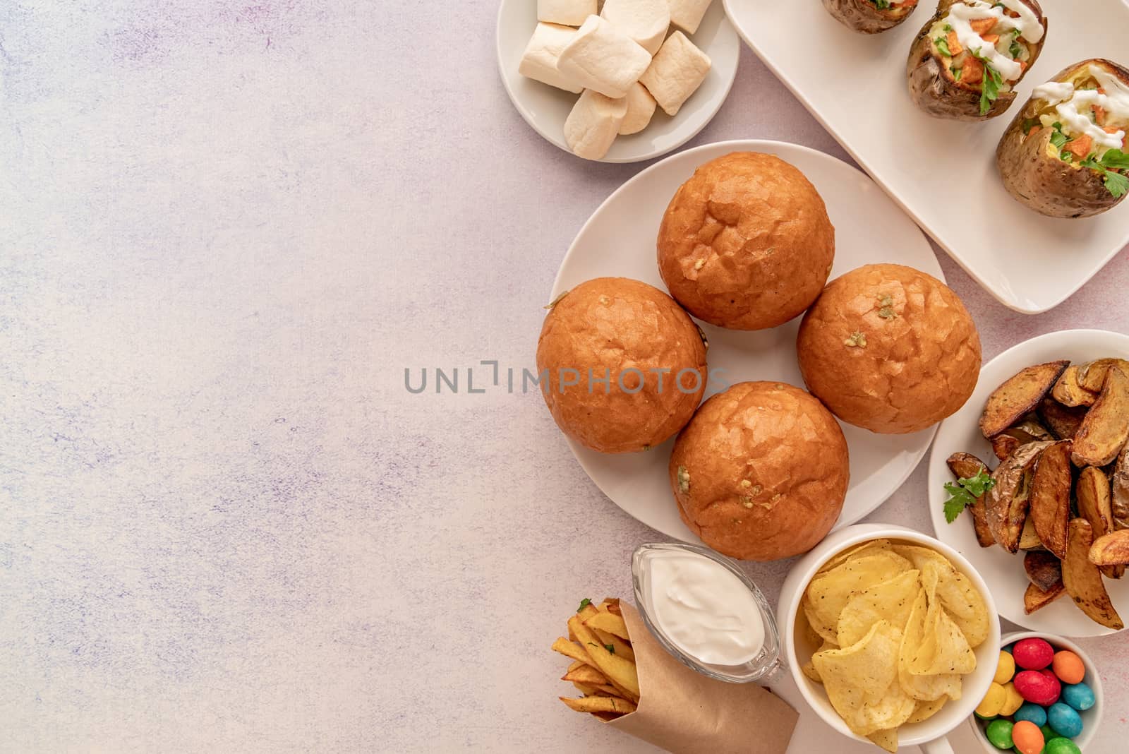 unhealthy food burgers, french fries and sweets top view flat lay with copy space by Desperada