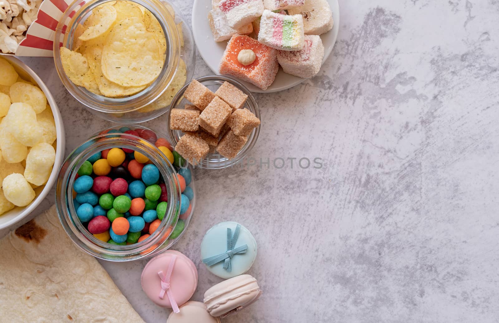 Healthy and unhealthy food concept. Unhealthy food burgers, french fries and sweets top view flat lay with copy space