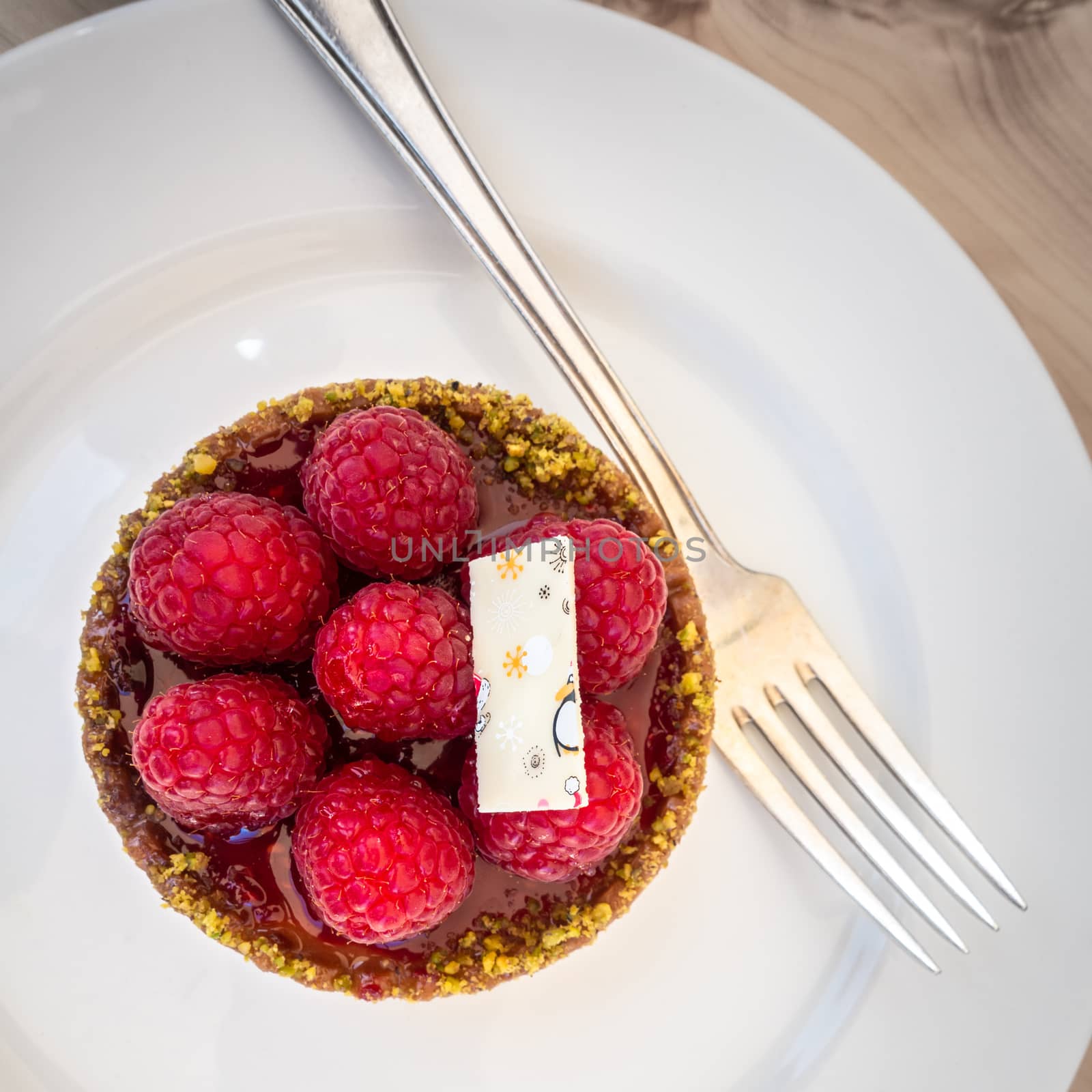 An image of a sweet raspberry tart with fork