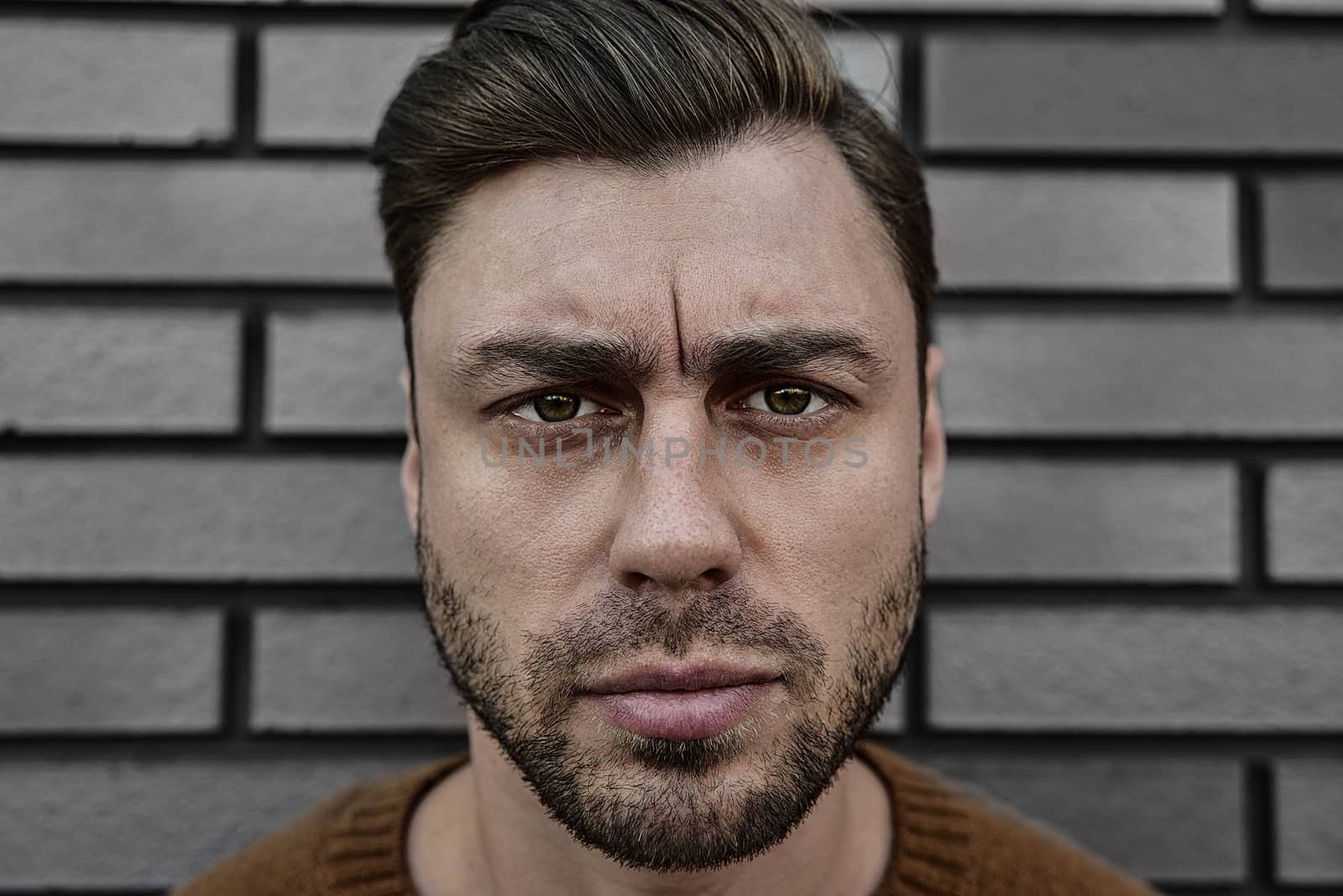 Portrait of a caucasian handsome man that is seriously frowning. Emotional face concept.