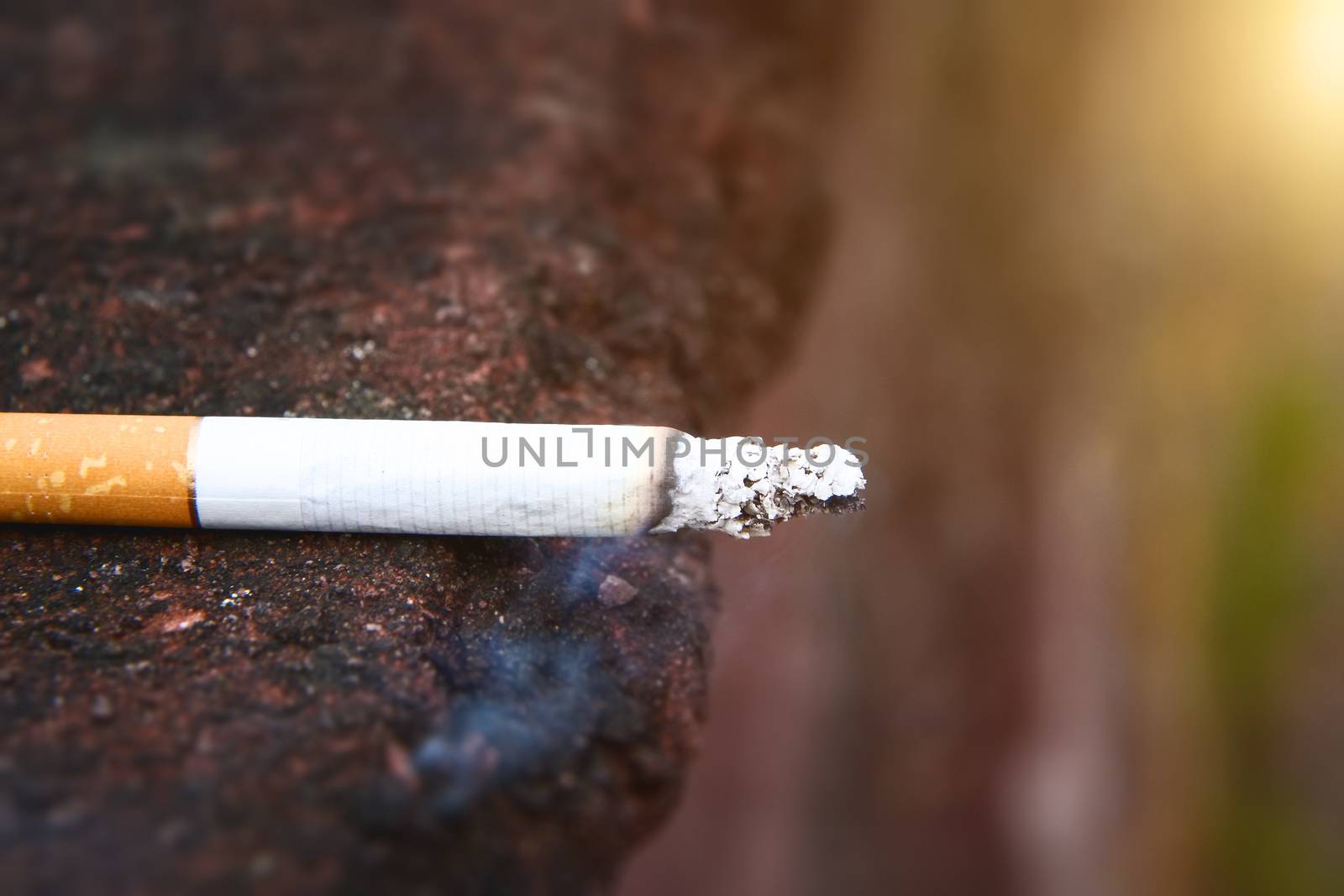 An image of a smoking cigarette side view