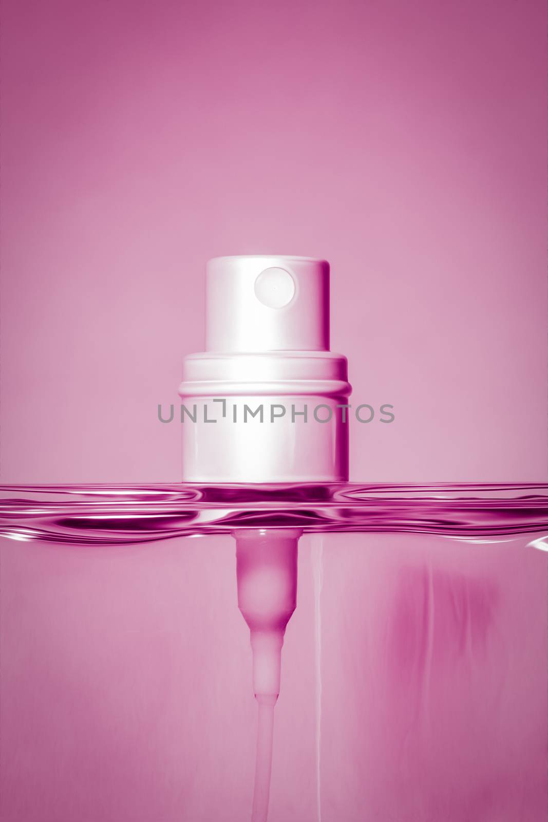 An image of a pink perfume bottle head detail