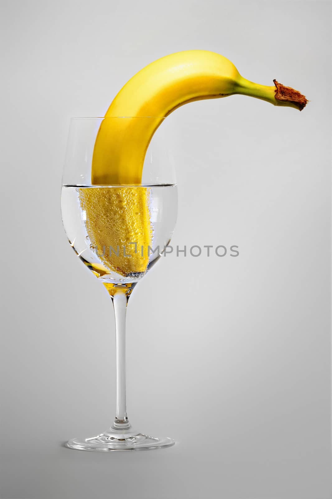 banana in a wineglass with water by magann