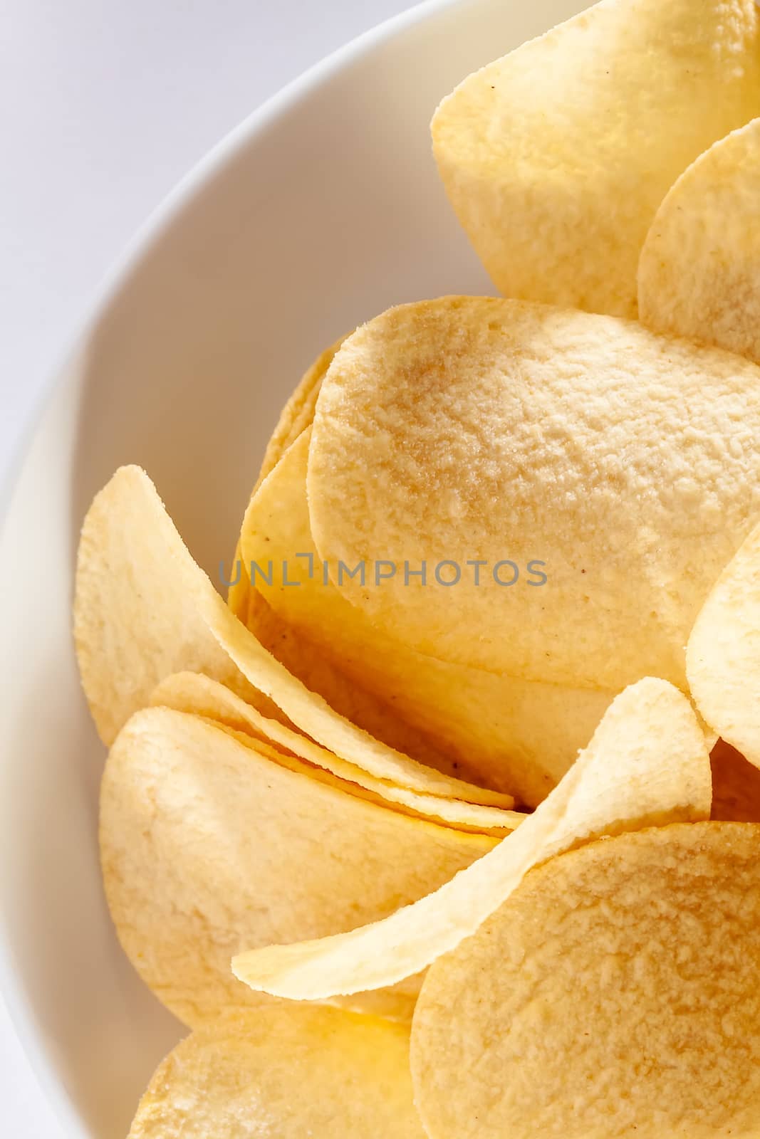 An image of some typical crisps in a white bowl