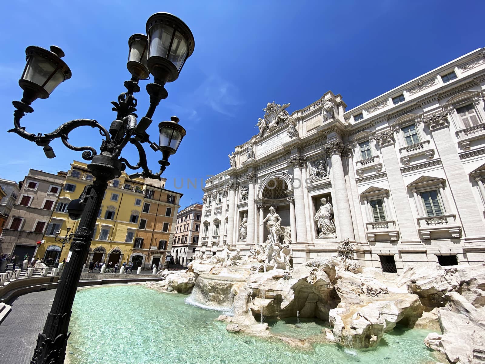 Rome, Italy, May 25th 2020: The Trevi Fountain in Rome with the first tourists after the lockdown due to the coronavirus pandemic. Access to the fountain is still prohibited by rarrarorro