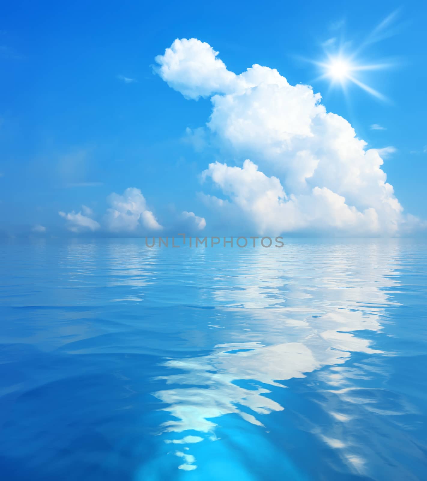 An image of the blue sky with white clouds and sun over the sea